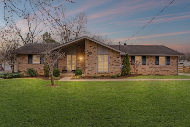 ranch-style home featuring a yard