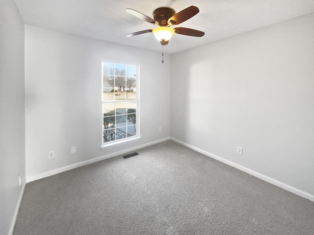 carpeted empty room featuring ceiling fan