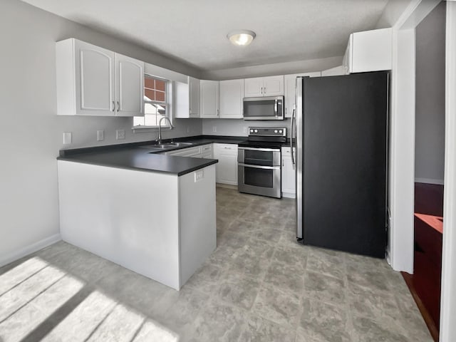 kitchen featuring stainless steel appliances, sink, and white cabinets