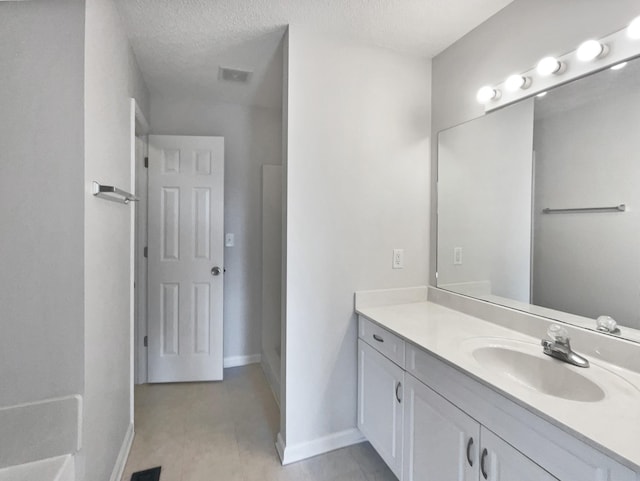 bathroom featuring vanity and a textured ceiling