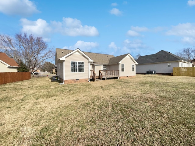 back of property featuring a yard and a deck