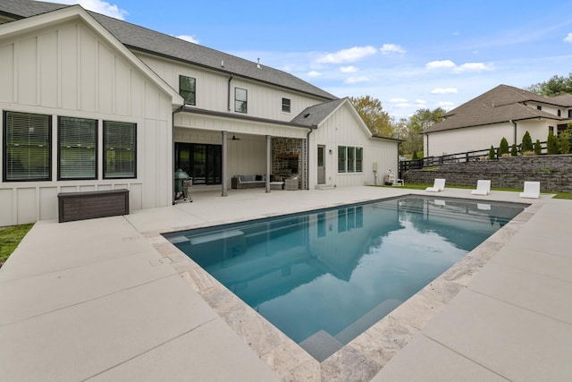 back of property featuring a fenced in pool, a patio area, and ceiling fan