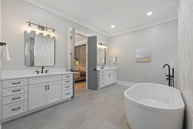 bathroom featuring ornamental molding, tile patterned flooring, vanity, and a washtub