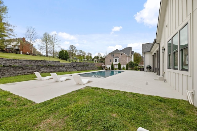 view of pool with a lawn and a patio area