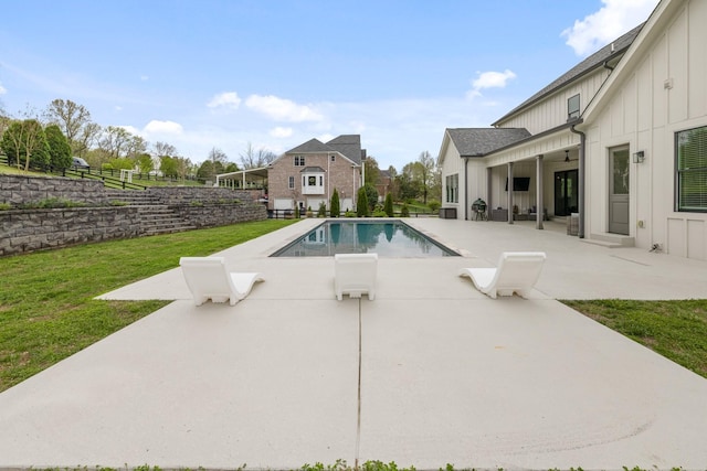 view of swimming pool with a yard and a patio area