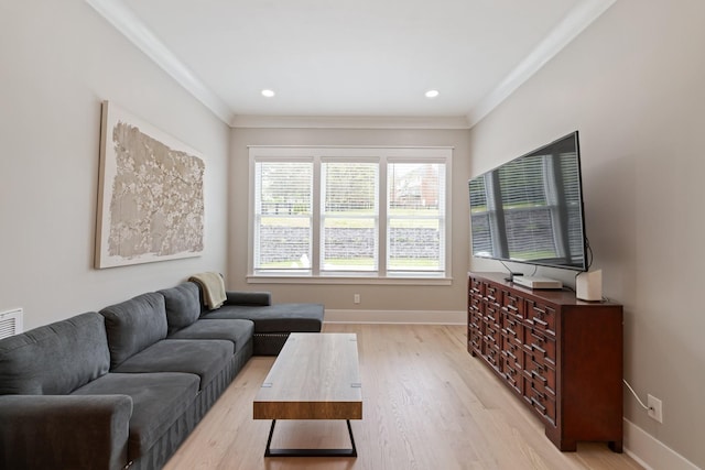 living room with ornamental molding and light wood-type flooring