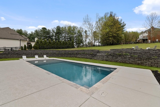 view of swimming pool with a patio area and a lawn