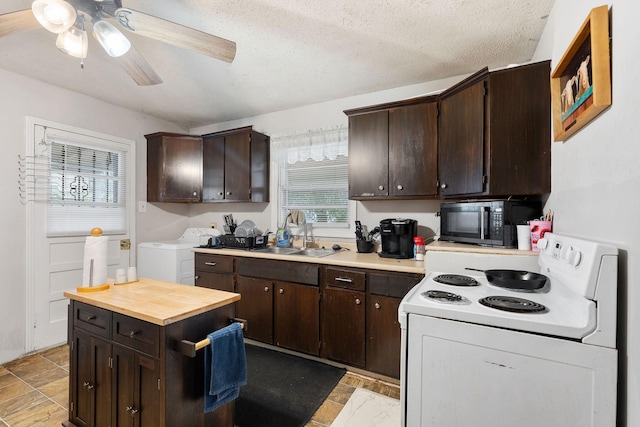 kitchen with washer and dryer, white electric range, sink, ceiling fan, and dark brown cabinets