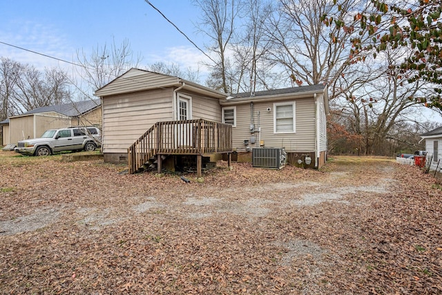 back of house with a wooden deck and central AC