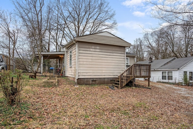 exterior space featuring a carport and a wooden deck