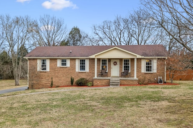 single story home with a front yard and covered porch