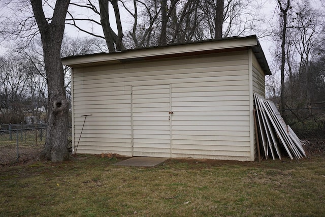 view of shed featuring fence