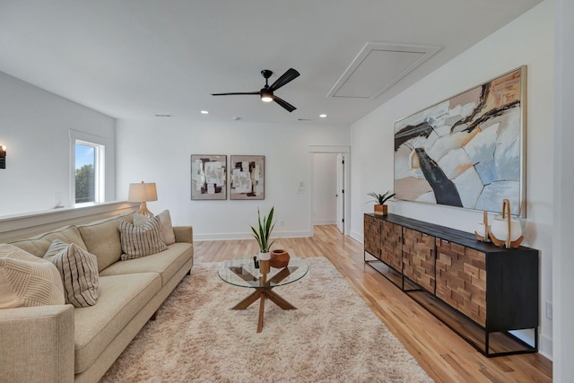 living room featuring light hardwood / wood-style floors and ceiling fan