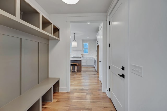 mudroom with light hardwood / wood-style floors