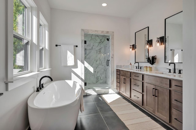 bathroom with vanity and independent shower and bath