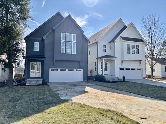 front facade with a garage and a front lawn