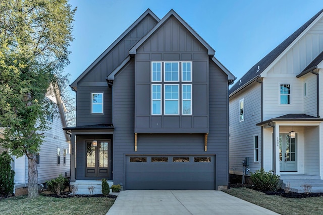 view of front of home with concrete driveway, french doors, board and batten siding, and an attached garage