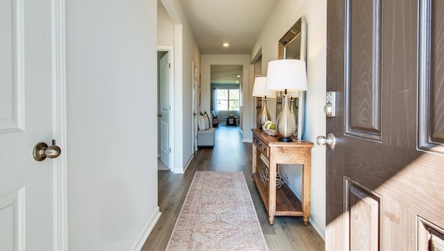 hall with hardwood / wood-style flooring