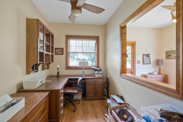 office area with light hardwood / wood-style floors and ceiling fan