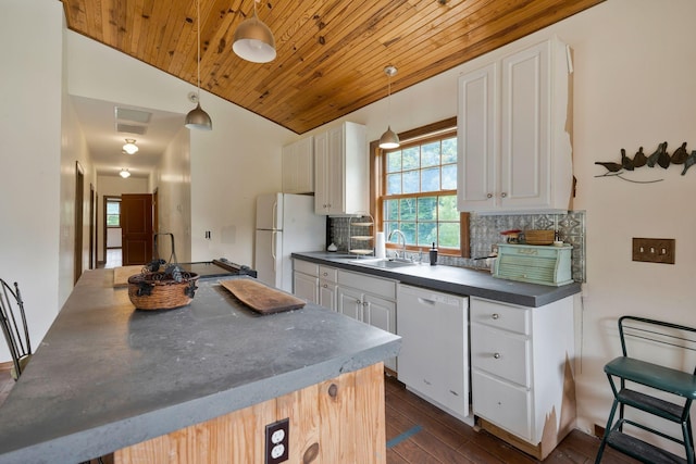 kitchen featuring sink, tasteful backsplash, pendant lighting, white appliances, and white cabinets