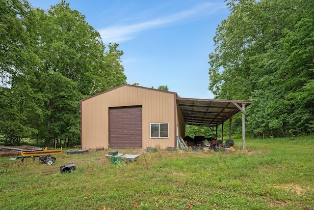 view of outbuilding featuring a carport, a garage, and a yard