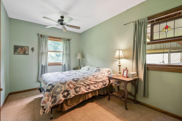 bedroom with ceiling fan and light tile patterned flooring