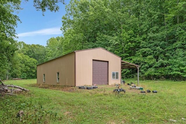 view of outdoor structure with a garage and a yard