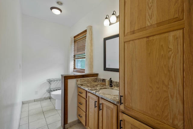 bathroom with vanity, tile patterned floors, and toilet