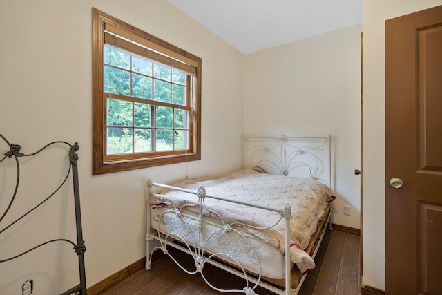 bedroom with dark hardwood / wood-style floors