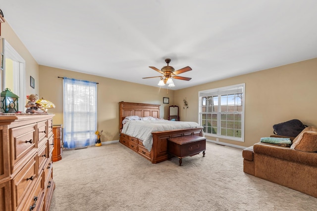 bedroom featuring light colored carpet and ceiling fan