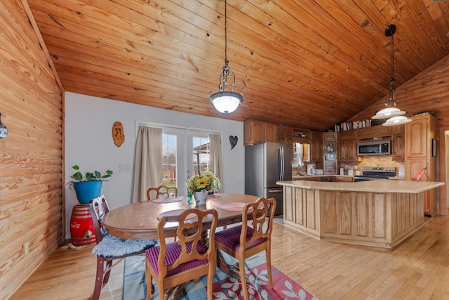 dining space featuring wood ceiling, lofted ceiling, and light wood-type flooring