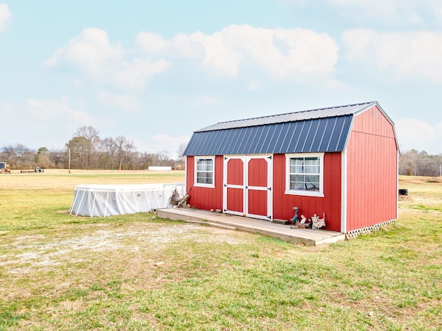 view of outbuilding with a yard