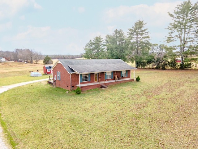 ranch-style home with a front yard and covered porch