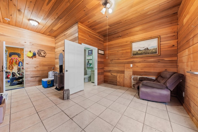 sitting room with light tile patterned floors, wooden walls, and wooden ceiling