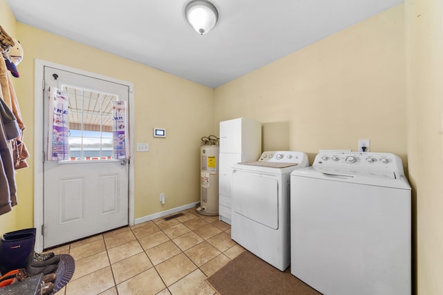 washroom with independent washer and dryer, electric water heater, and light tile patterned floors