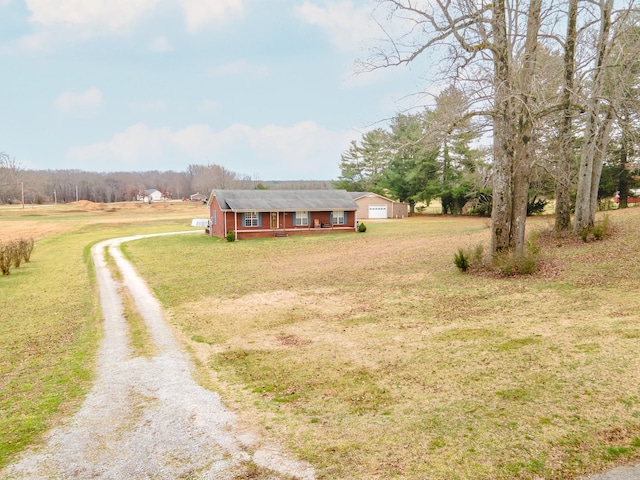 view of front of home with a garage, covered porch, and a front lawn