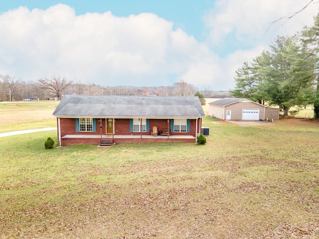 ranch-style home featuring a garage, an outdoor structure, covered porch, and a front lawn