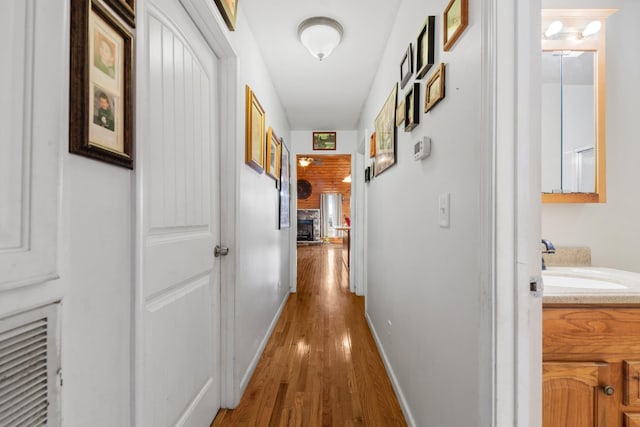 hall featuring sink and hardwood / wood-style floors