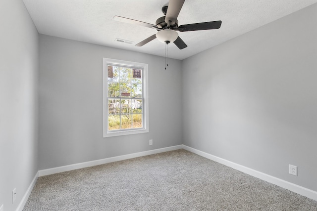 unfurnished room with carpet, visible vents, and baseboards