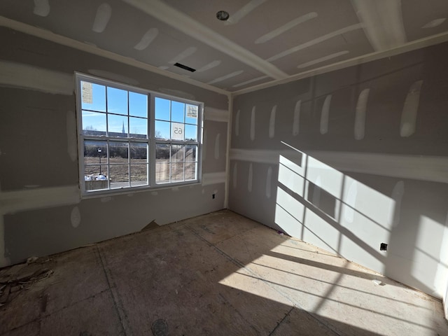 unfurnished room featuring visible vents