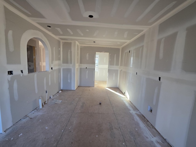 unfurnished room featuring arched walkways