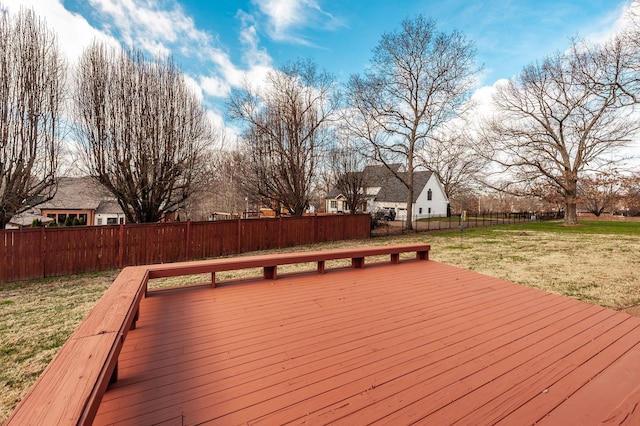 wooden terrace featuring a lawn