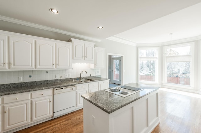 kitchen featuring white cabinetry, a healthy amount of sunlight, white appliances, and decorative light fixtures