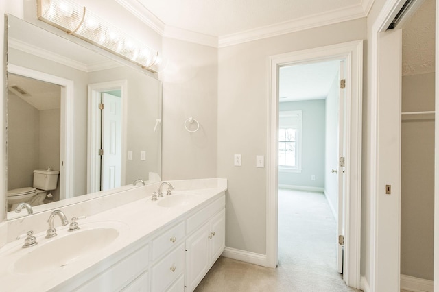 bathroom featuring ornamental molding, vanity, and toilet