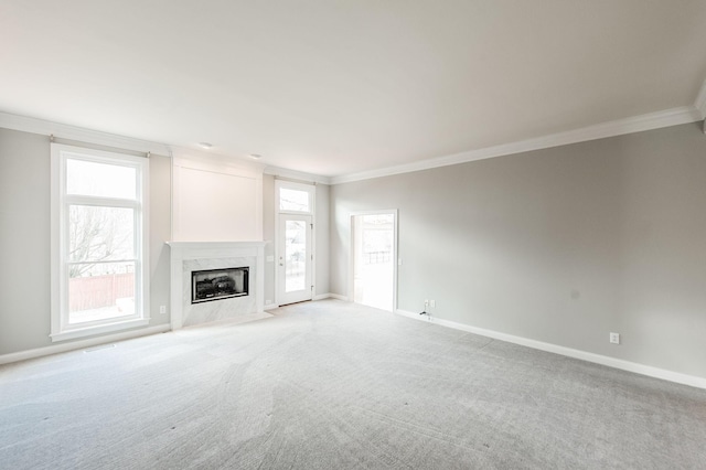 unfurnished living room with carpet flooring, ornamental molding, and a fireplace