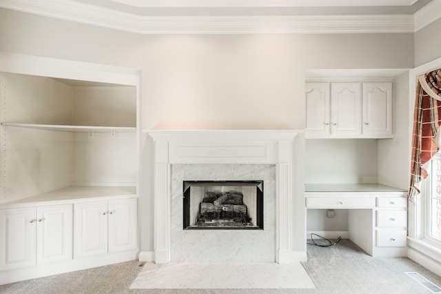 unfurnished living room featuring crown molding, a fireplace, and light carpet