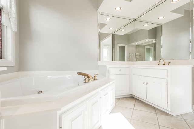 bathroom with vanity, tile patterned floors, and a bathtub