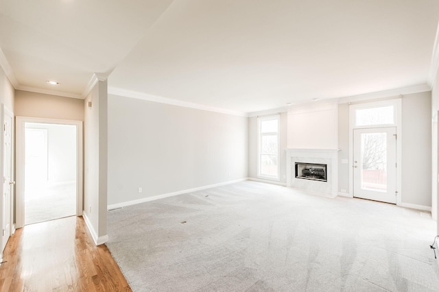 unfurnished living room with crown molding and a high end fireplace