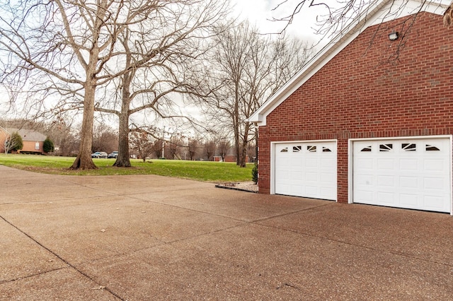 view of side of home featuring a yard and a garage