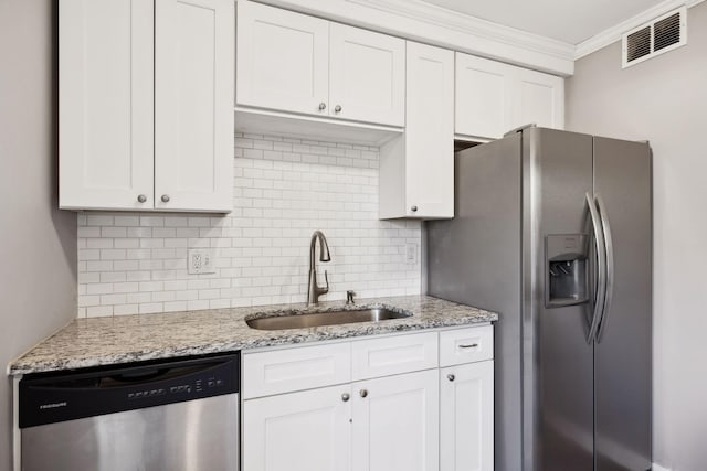 kitchen featuring stainless steel appliances, ornamental molding, sink, and white cabinets